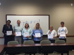 volunteers holding their certificates