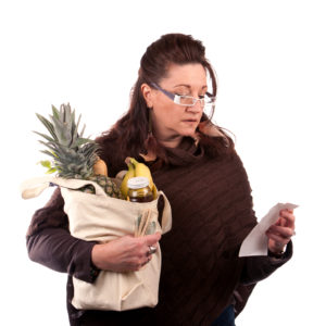 Woman looking at grocery receipt