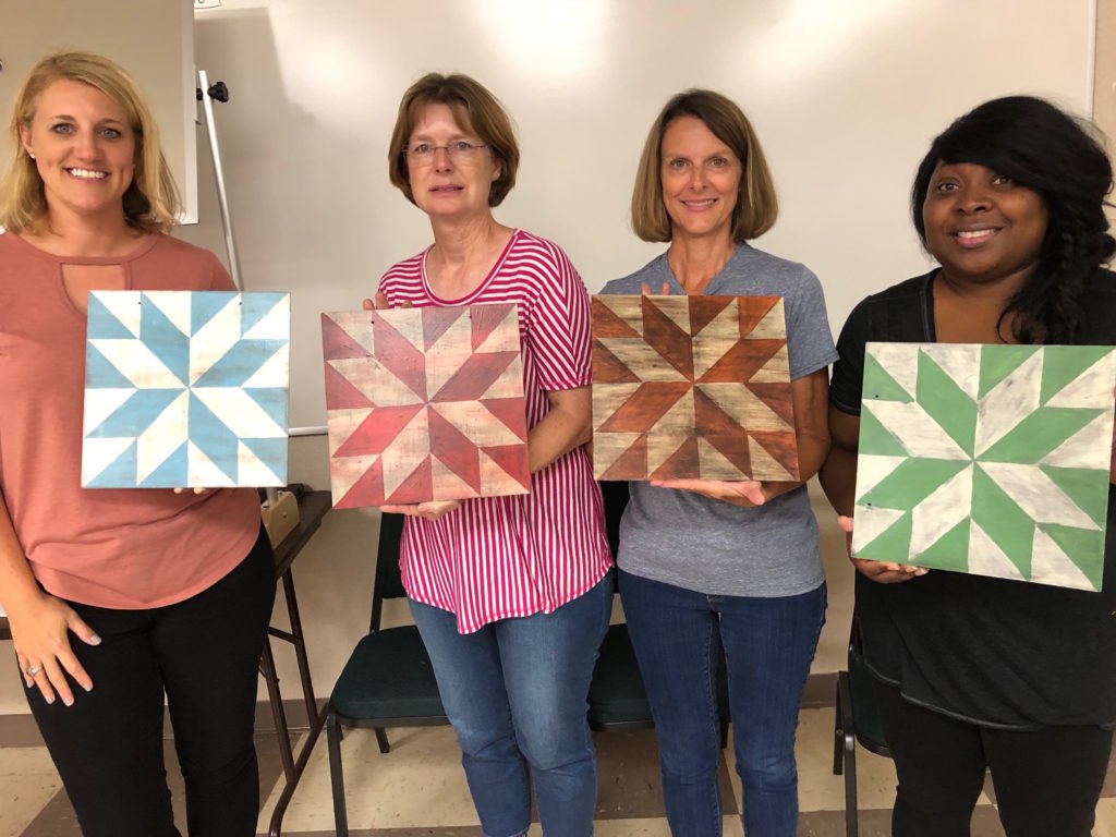 4 women with painted barn squares