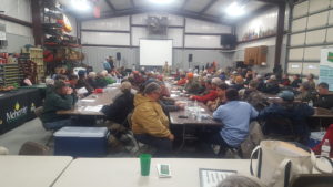 people sitting at tables attending AG meeting