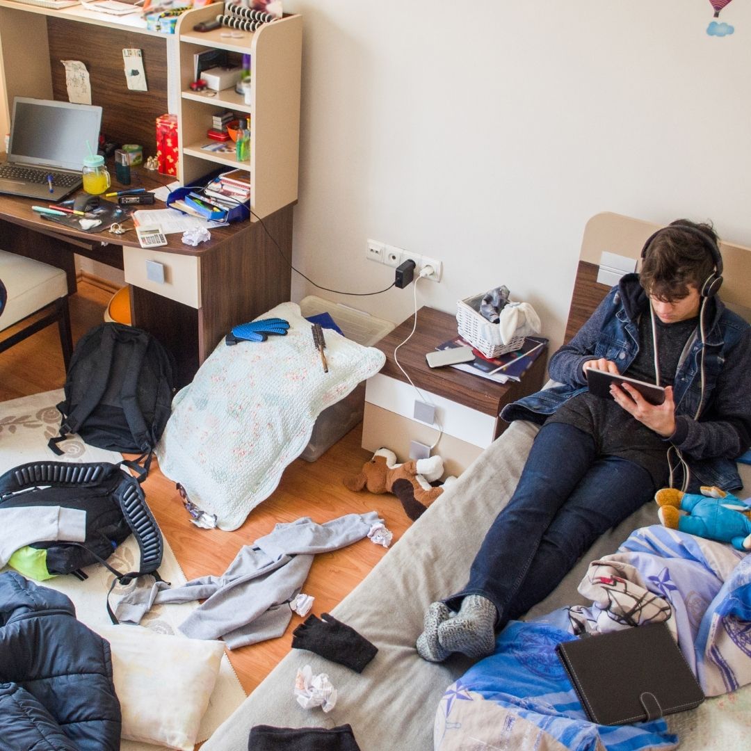 teenage in messy bedroom