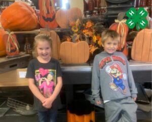 two kids with pumpkins