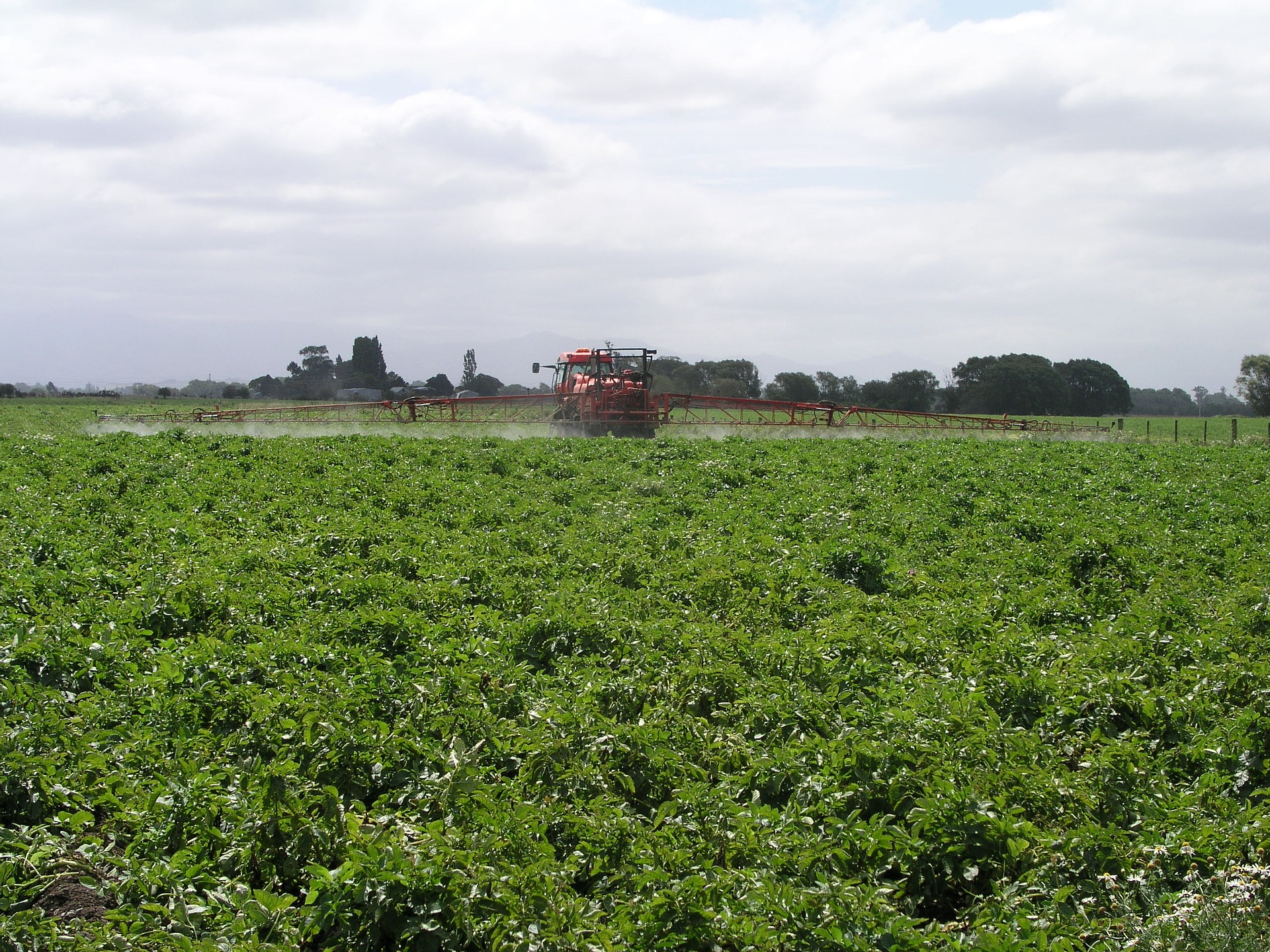 tractor spraying farm fields