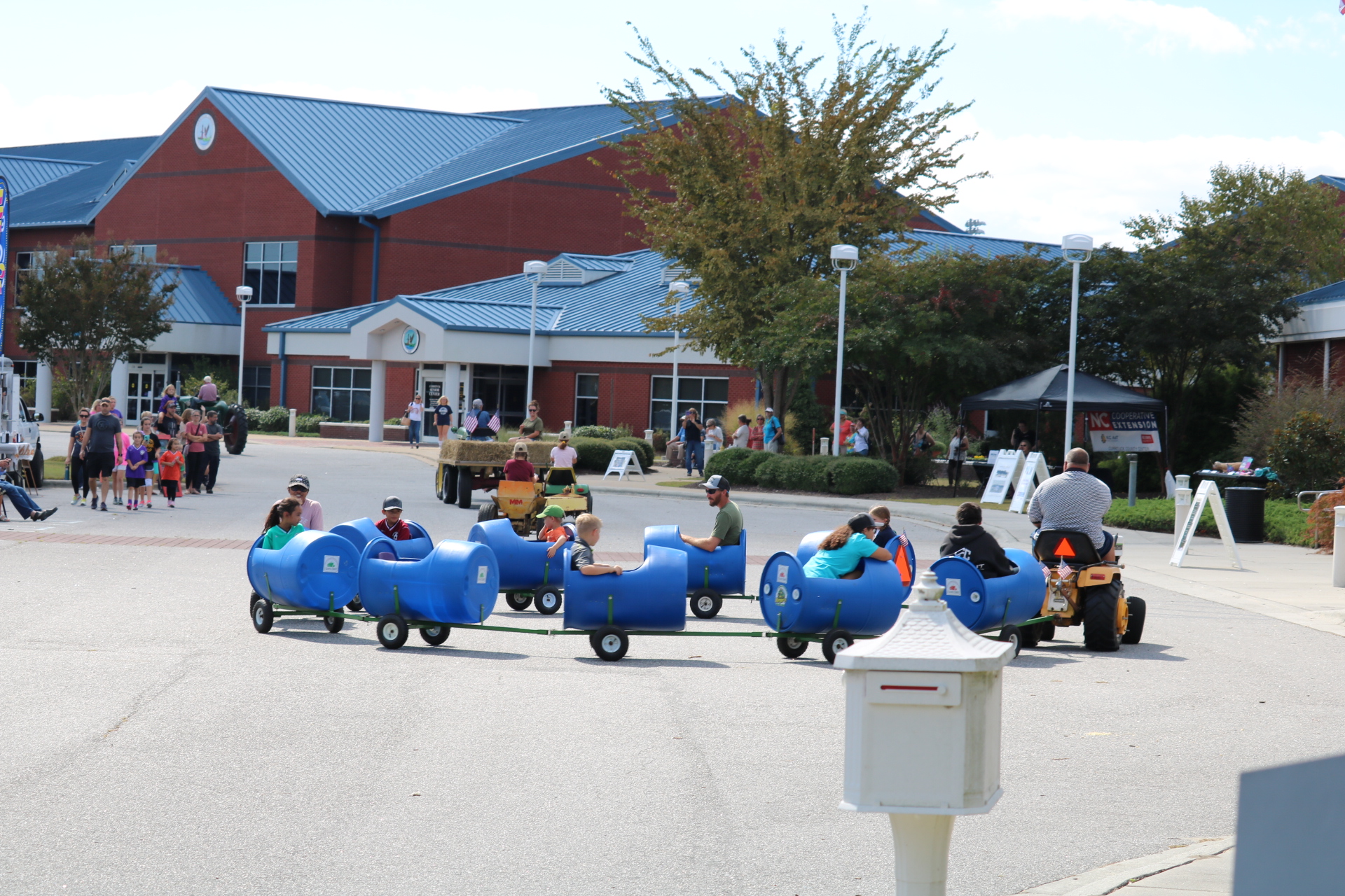 lawn tractor pulling barrel cars