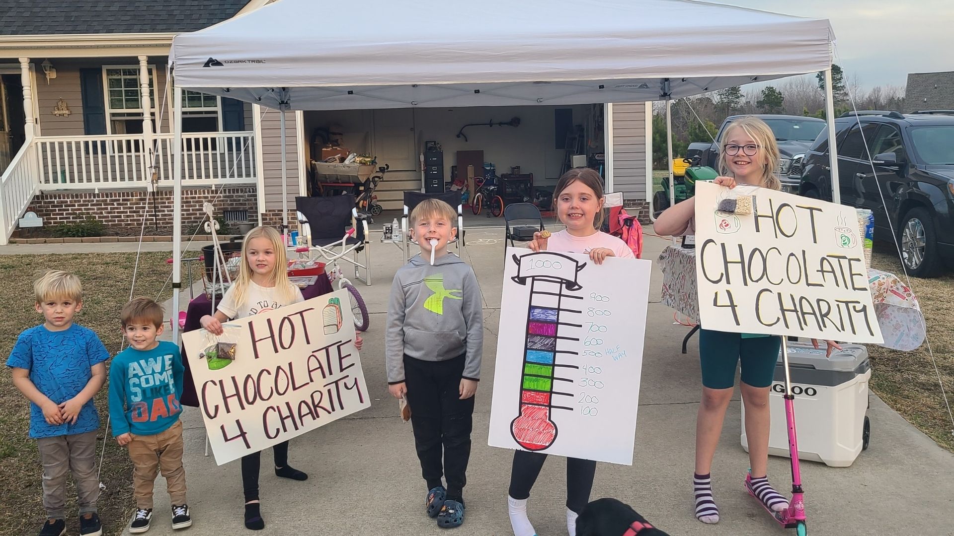 Skylar Hill (2nd from right) poses with friends in front of their hot cocoa stand. These young people donated all the proceeds to the Currituck 4-H Backpacks for Kids Program